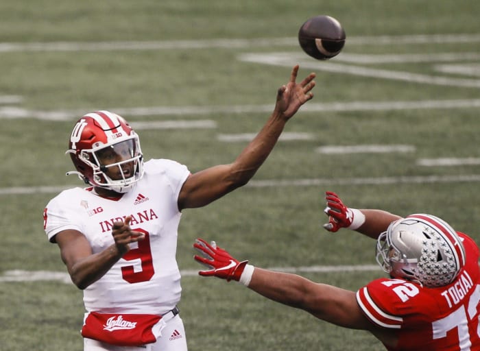 Indiana Hoosiers quarterback Michael Penix Jr. (9) passes as Ohio State Buckeyes defensive tackle Tommy Togiai (72) pressures during the fourth quarter of a NCAA Division I football game between the Ohio State Buckeyes and the Indiana Hoosiers on Saturday, Nov. 21, 2020 at Ohio Stadium in Columbus, Ohio.